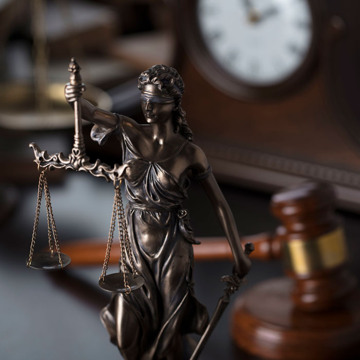 A lady Justice statue on a desk symbolizing civil litigation and legal fairness in Florida