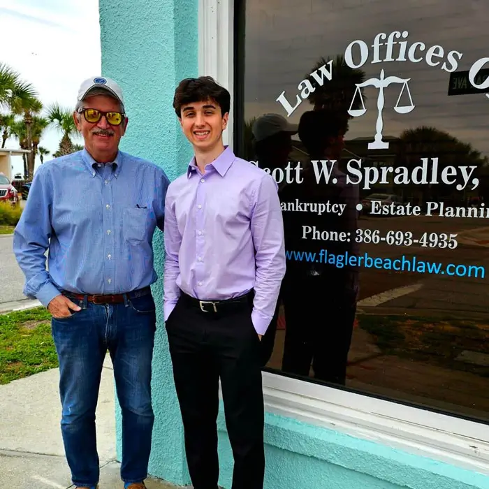 Summer associate, Sam, next to Scott W. Spradley at the law office in Flagler Beach, FL